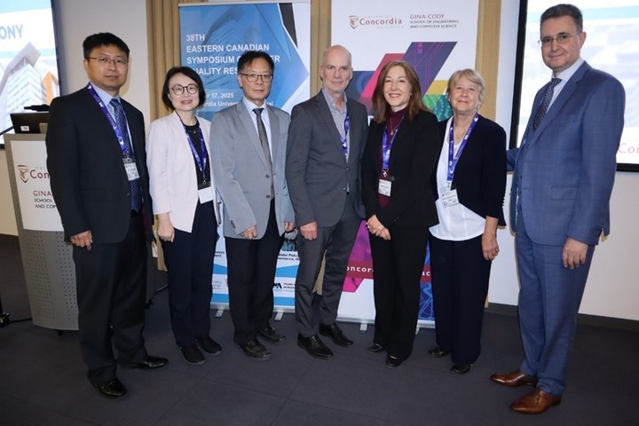 Caterina Valeo with fellow keynote speakers and organizers in front of the 38th Eastern Canadian Symposium on Water Quality Research banner at Concordia University